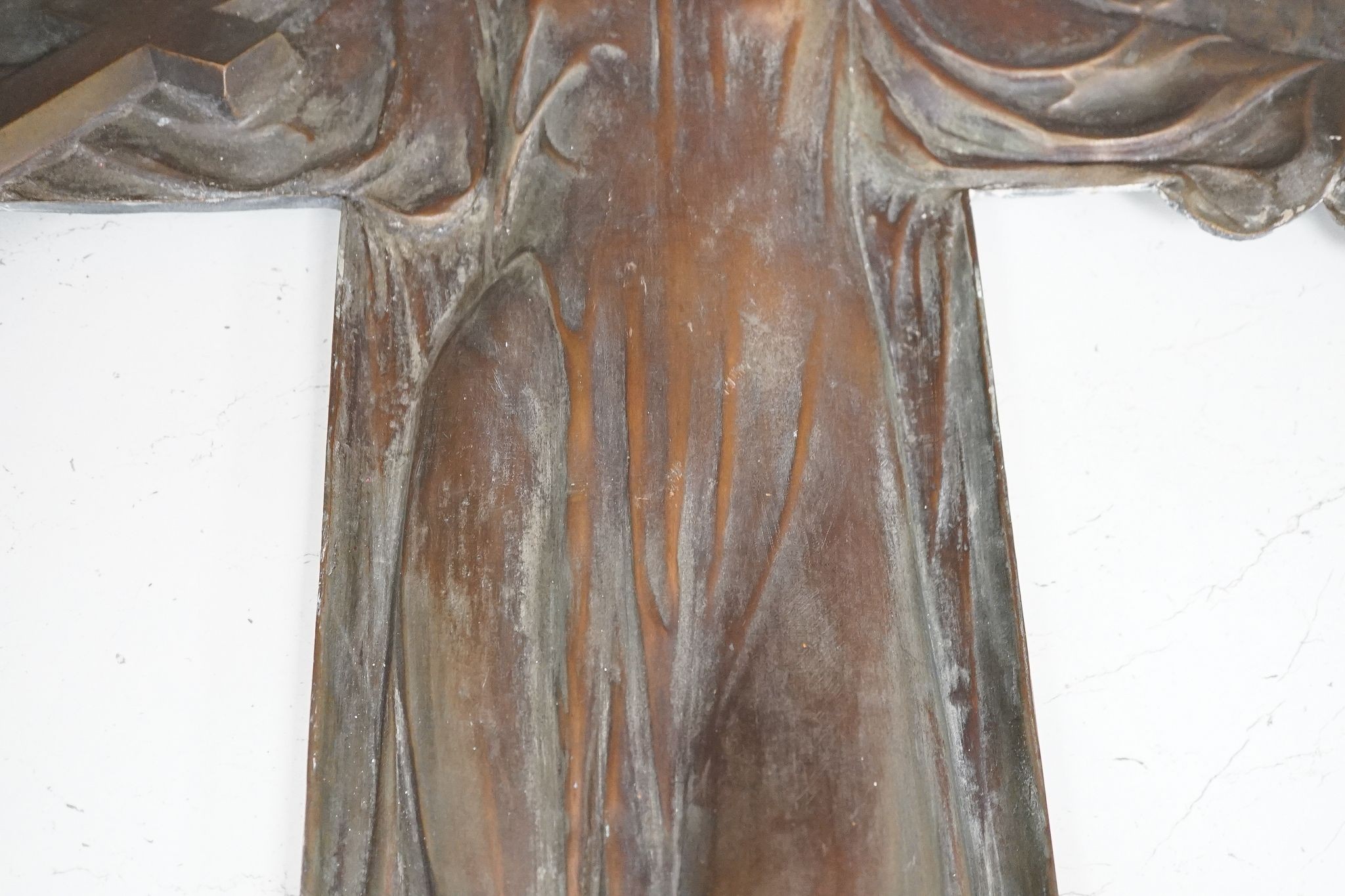 A cast bronze angel, initialled ‘P.D’ to bottom right, 72cm